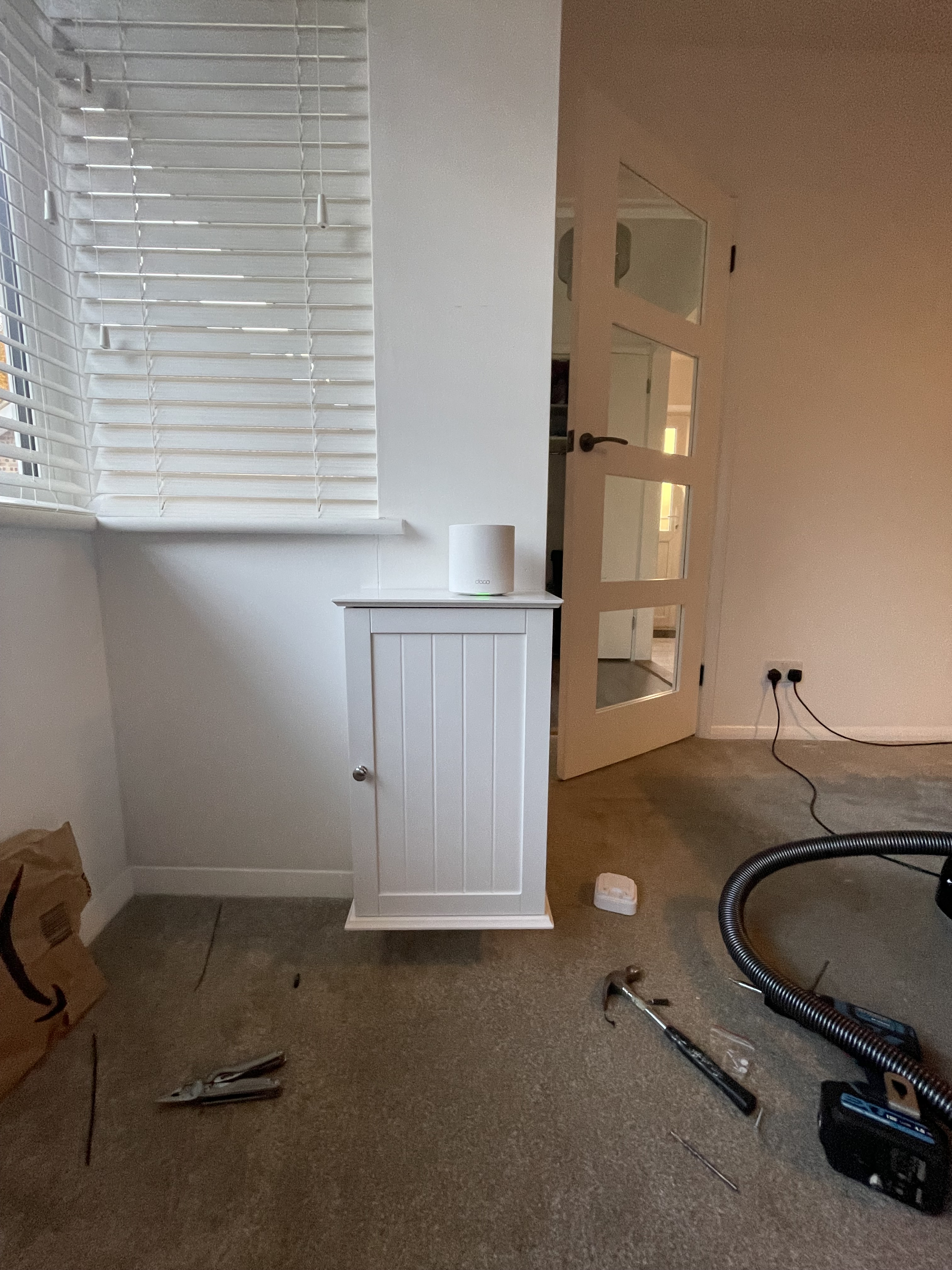 Mesh router sitting atop router cabinet